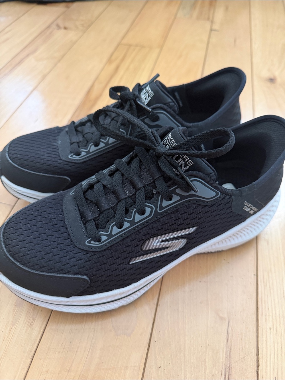 Skechers Black and White Mesh Lace-Up design but an easy slip on sneaker